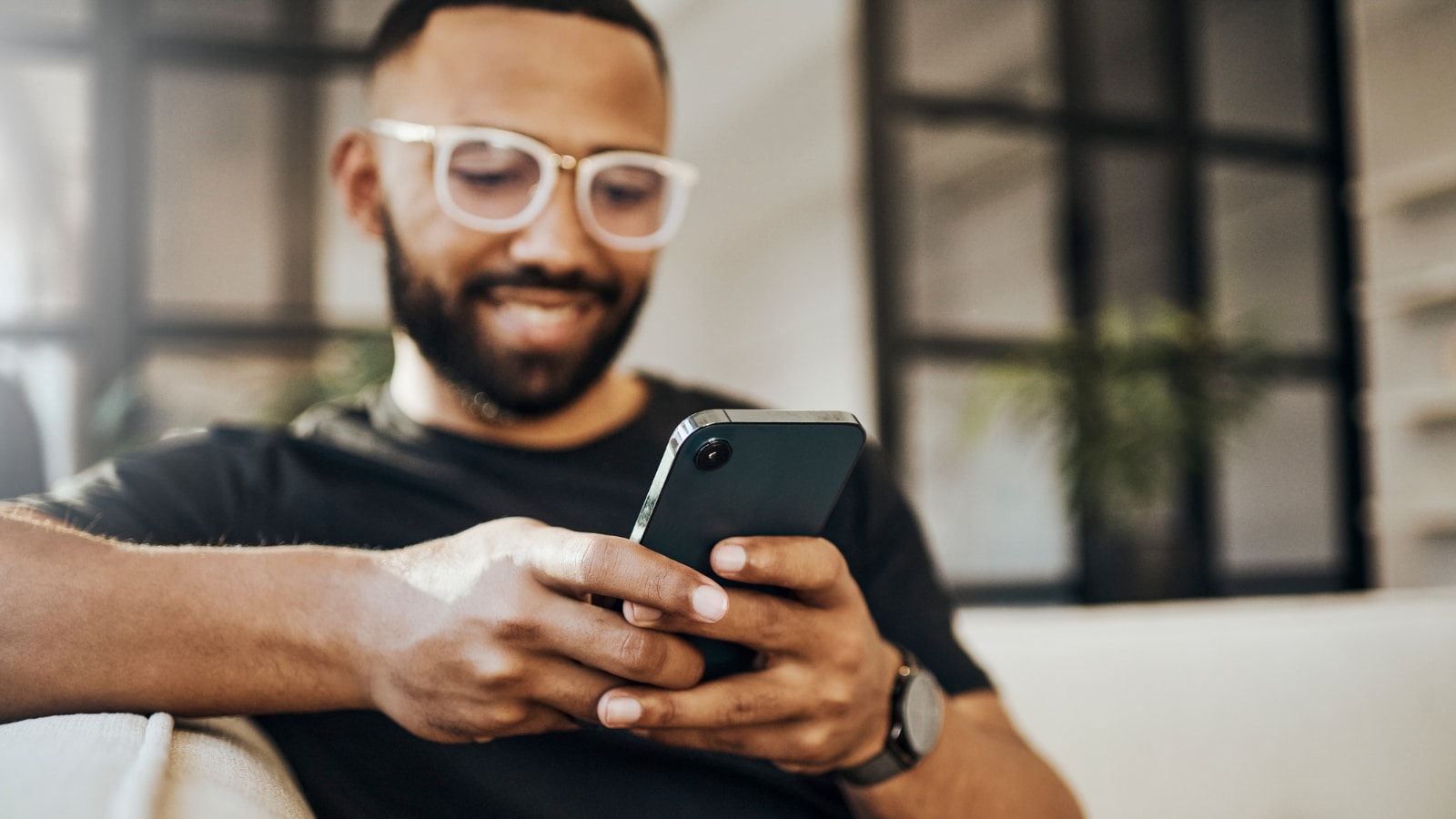 Young man reading about health insurance on his phone.