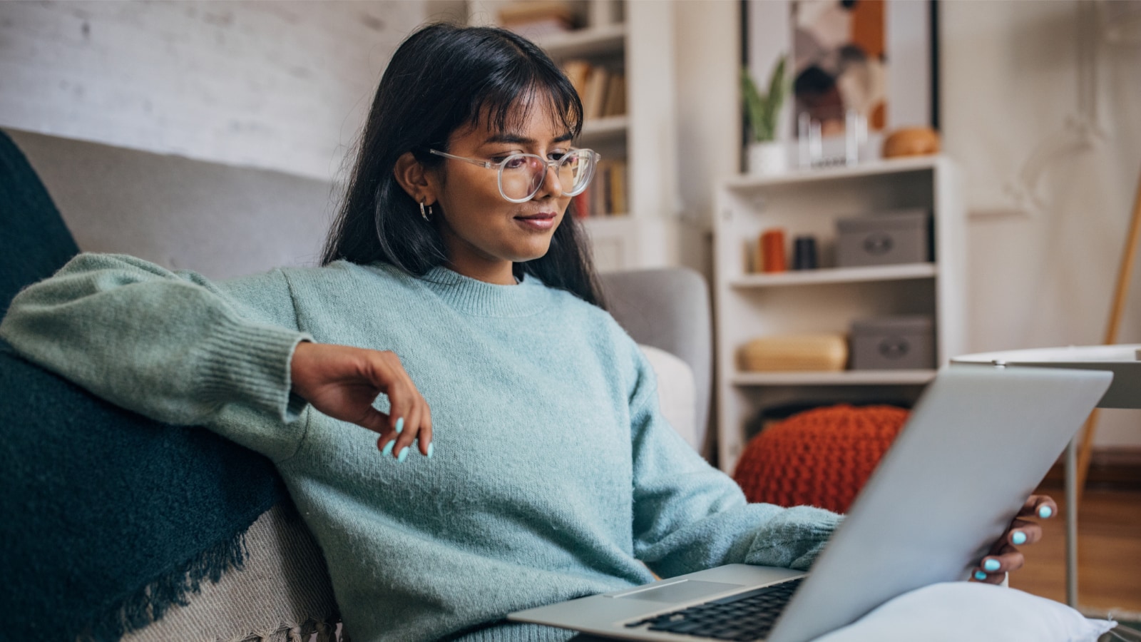 Young woman reading on laptop